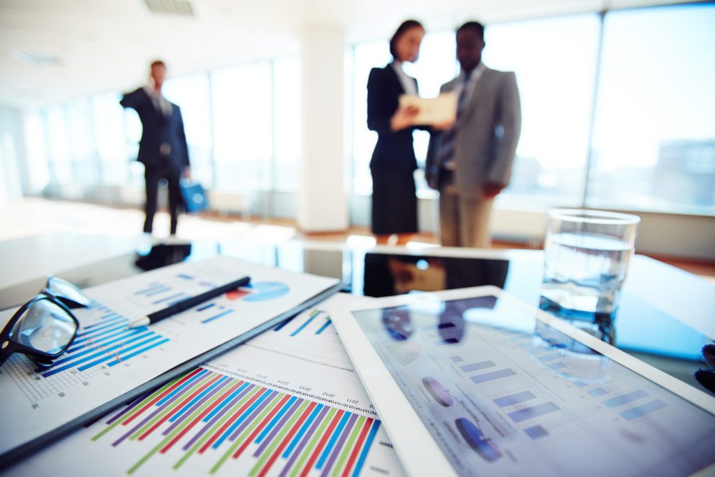 Paper and electronic business documents on desk